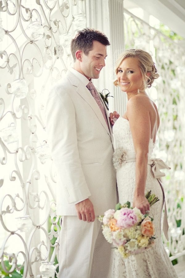 A classic white suit was perfect for this Southern garden wedding. Image by Eyeris Photography