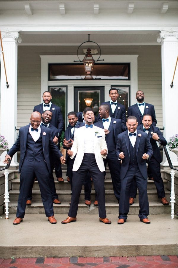 A tuxedo is always is style! Our groom Sydney stands out in his white jacket while the rest of this groomsmen are rocking the classic black. Image: Lindsey Campbell