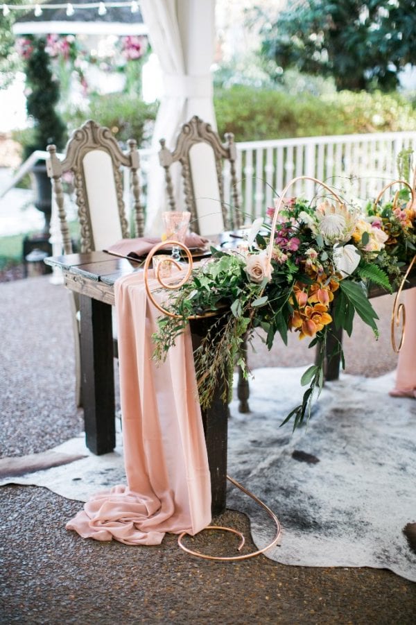 This boho beauty of a sweetheart table looks incredible in our Southern garden wedding venue.
