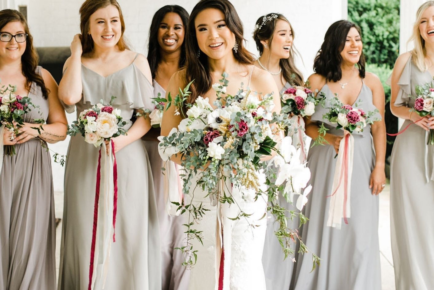 CJ's Off the Square | Bridesmaids in neutral colors with bouquets