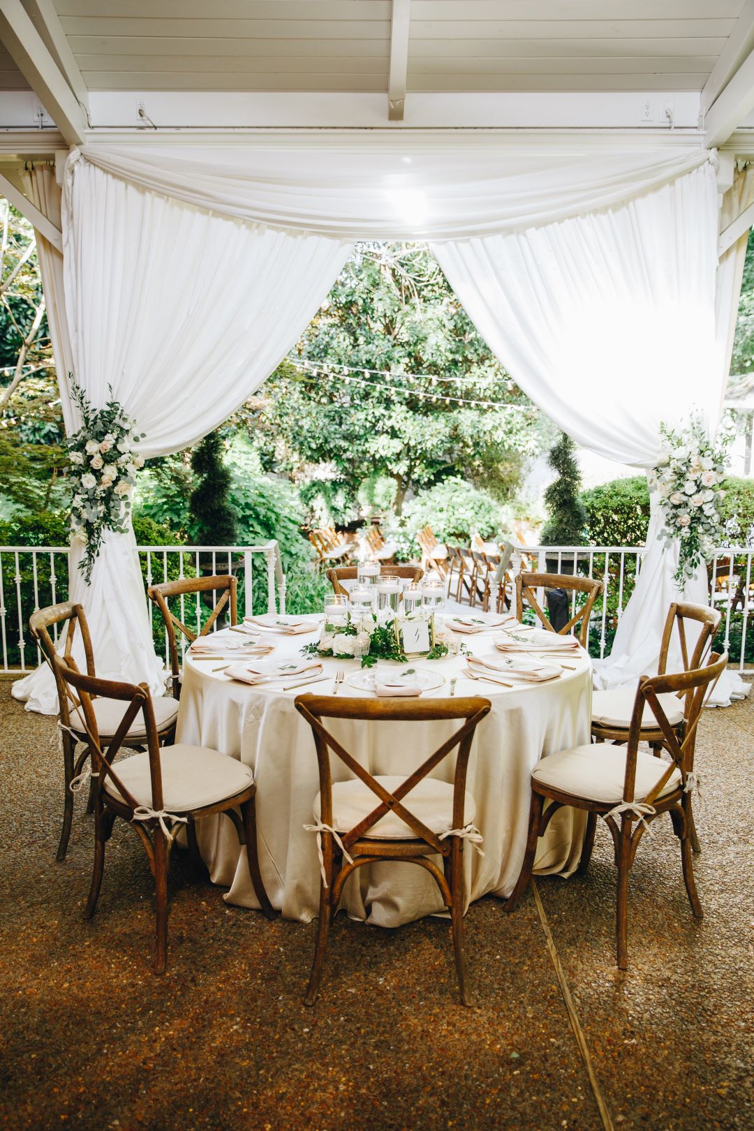 Table setting with rose accents at earthy summer garden wedding in September, neutrals & greenery