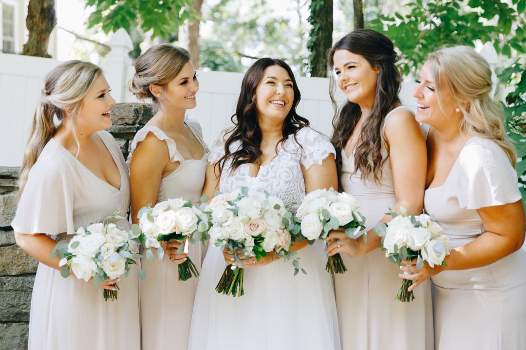 Bridal party laughing during portraits for earthy summer garden wedding in September, neutrals & greenery