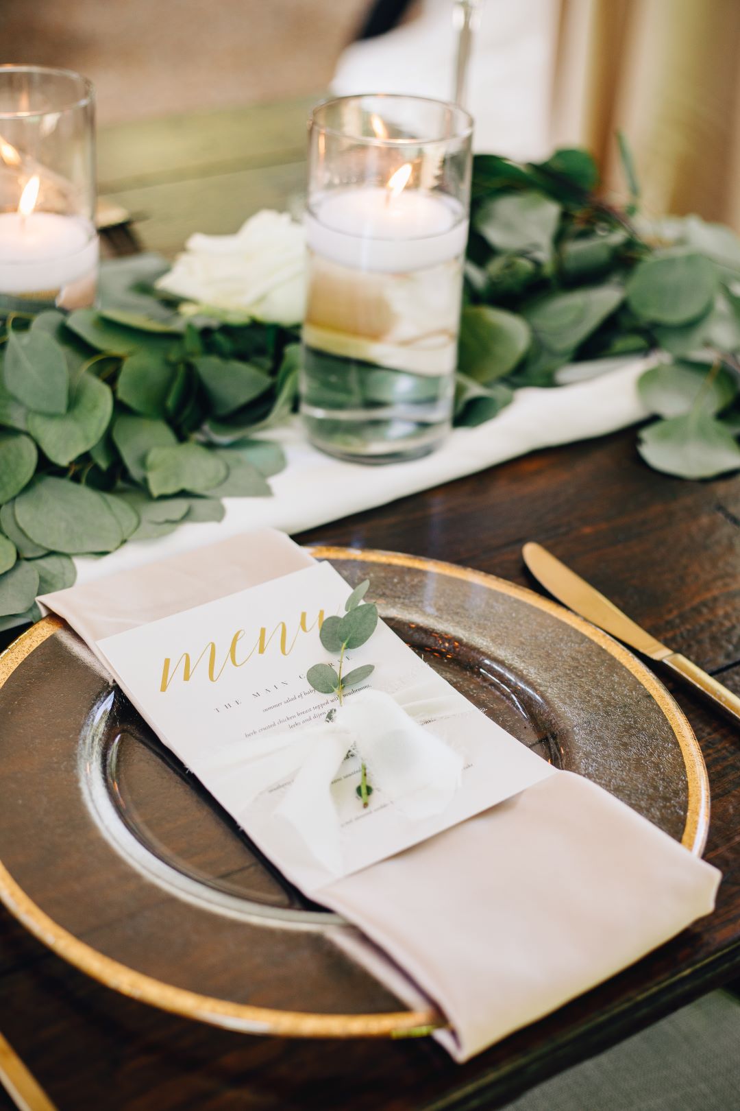 Place settings with blush napkins at earthy summer garden wedding in September, neutrals & greenery