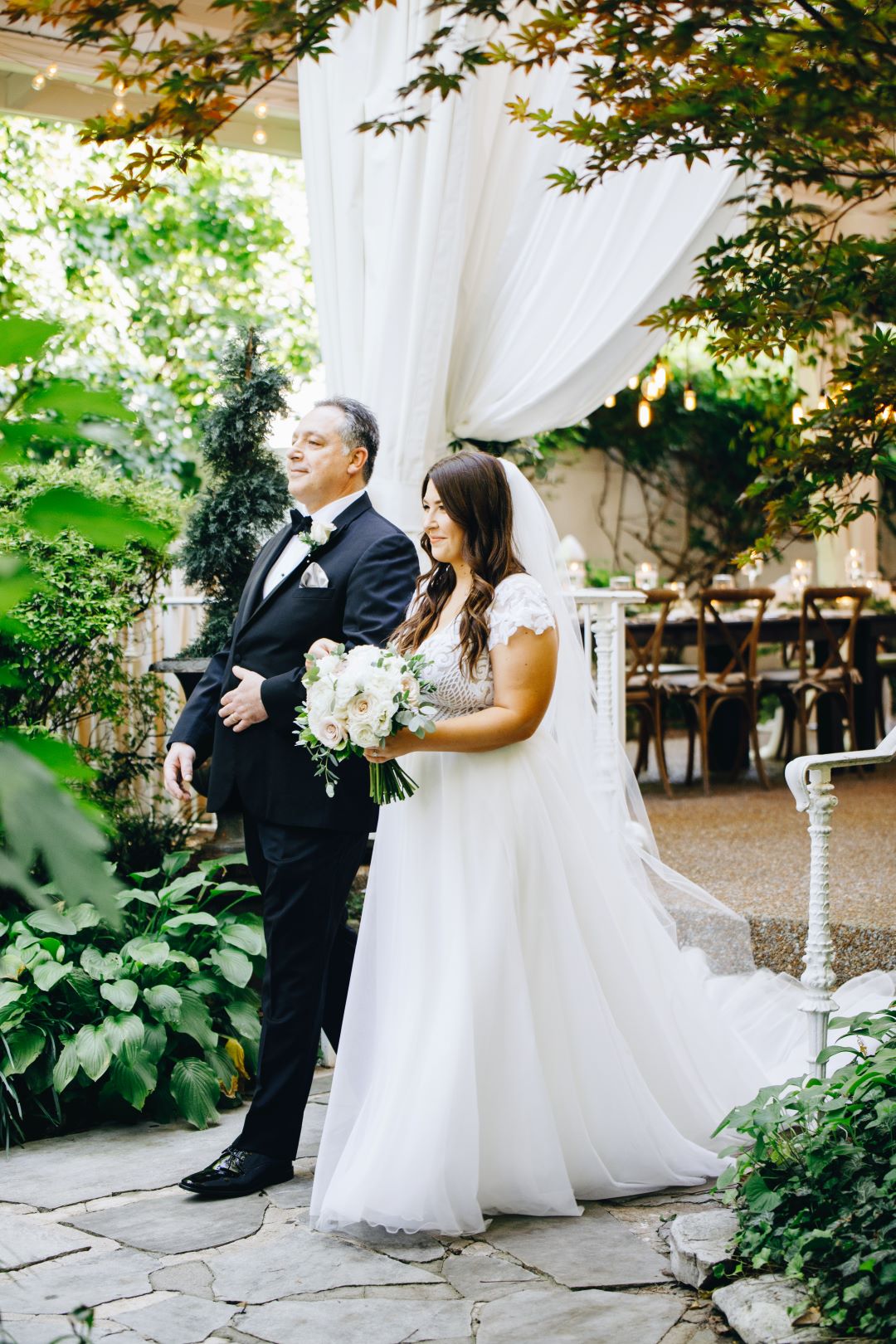 Bride walking down the aisle with her father at earthy summer garden wedding in September, neutrals & greenery