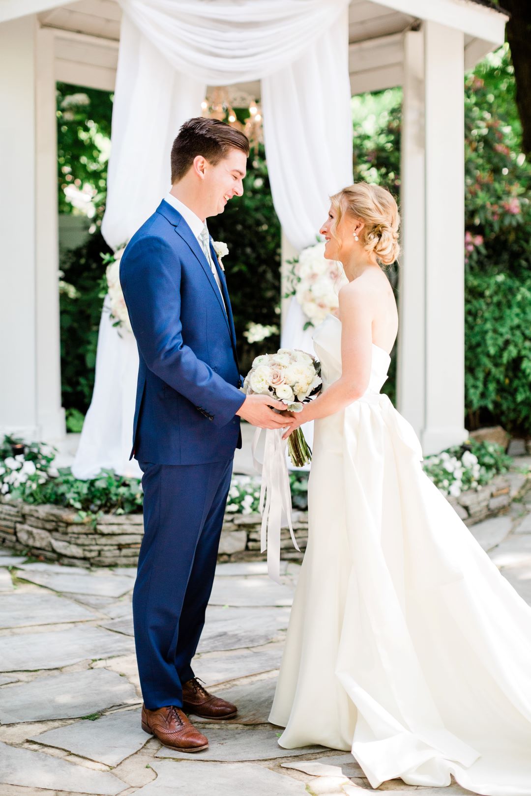 CJ's Off The Square | Bride and groom holding hands in the garden during their first look