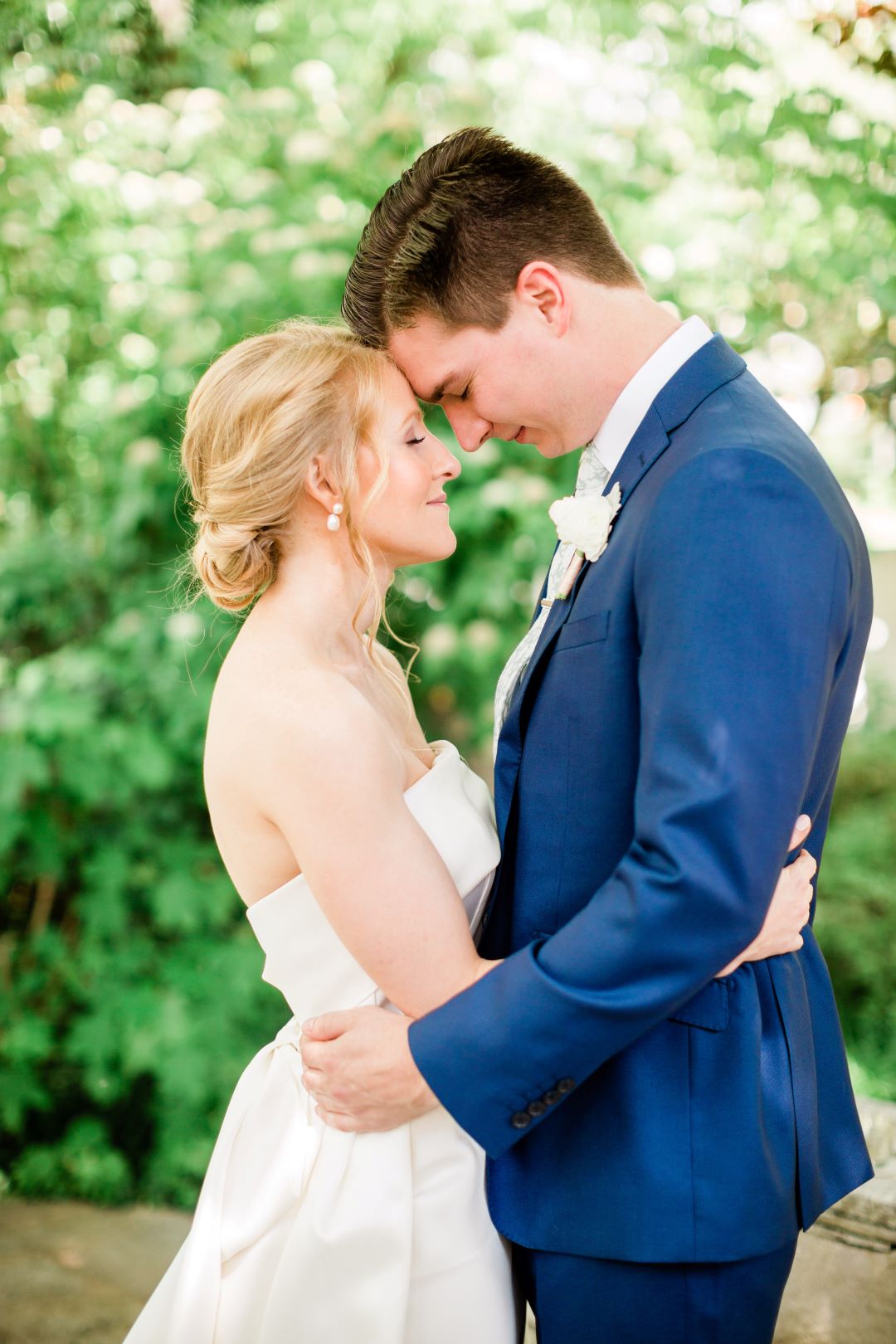 CJ's Off The Square | Bride and groom hugging and touching foreheads during portraits