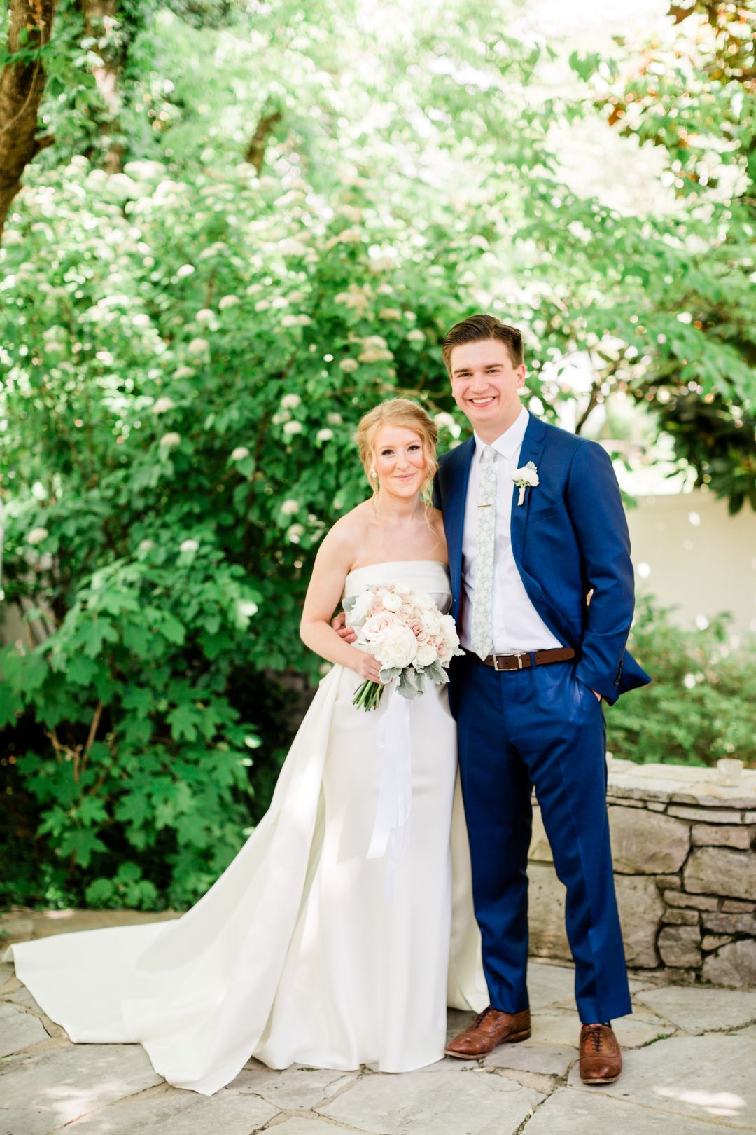 CJ's Off The Square | Bride and groom posing for portraits in the garden of the wedding venue