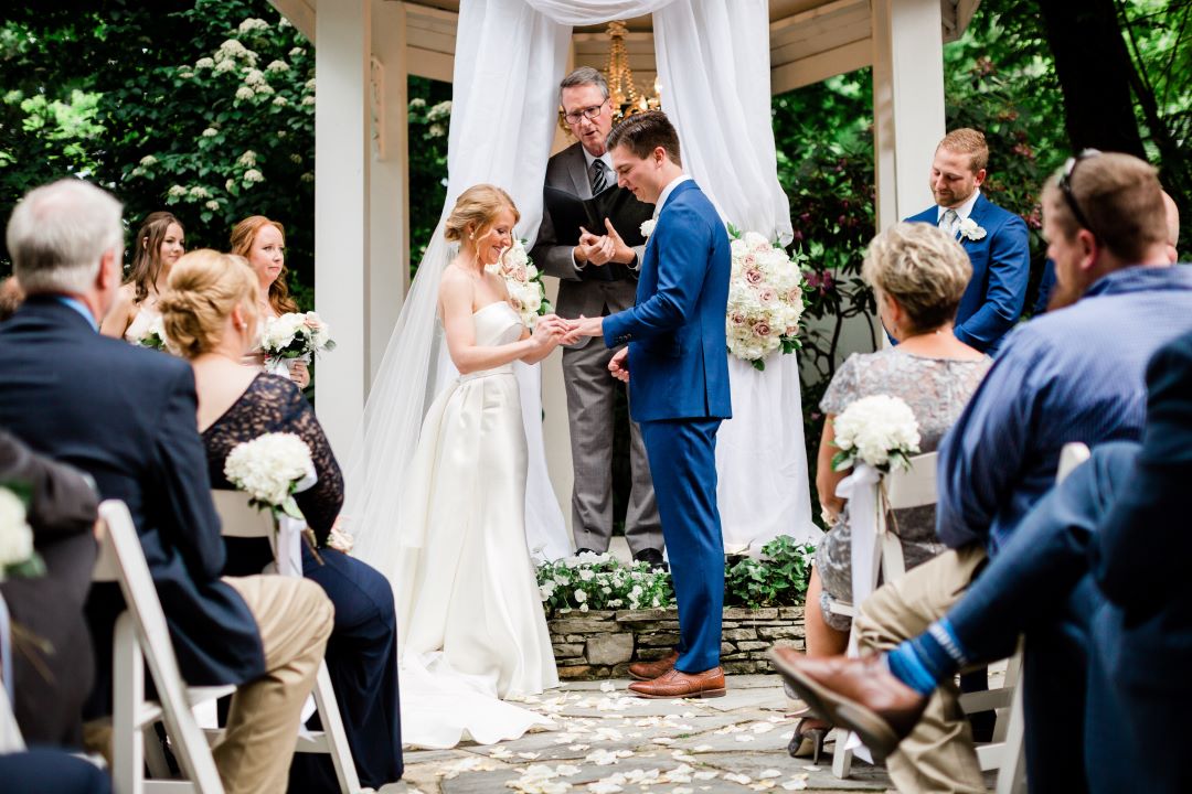 CJ's Off The Square | Bride placing the groom's ring on his finger