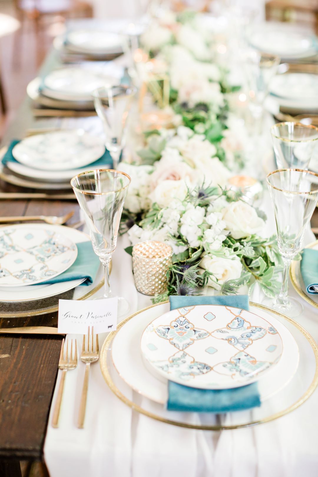 CJ's Off The Square | Classic blue linens and printed plates with blush and white floral table runner
