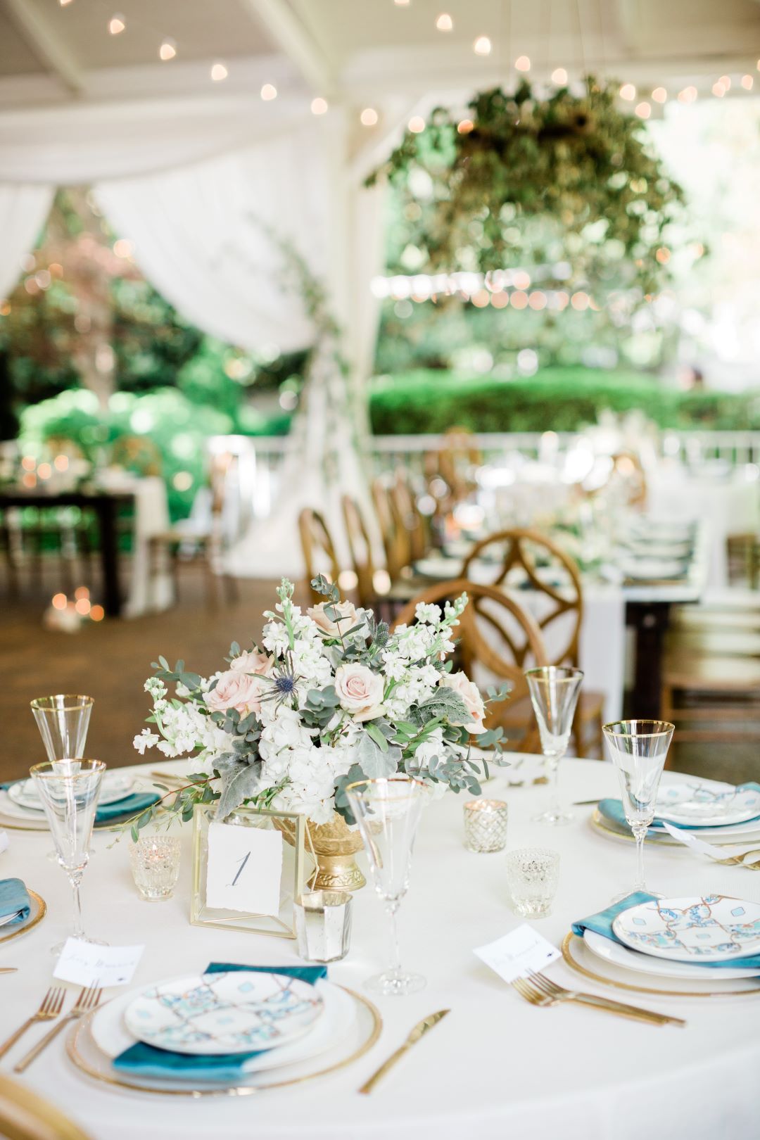 CJ's Off The Square | Beautiful floral centerpiece and table settings for romantic garden wedding