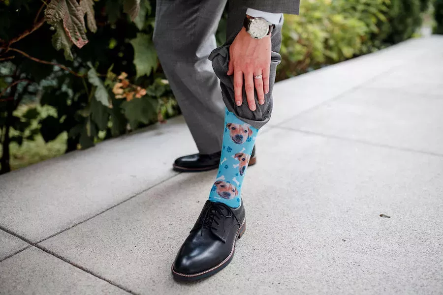Her groom wore a gray suit from Joseph A Banks and personalized socks featuring their adorable dog’s face.