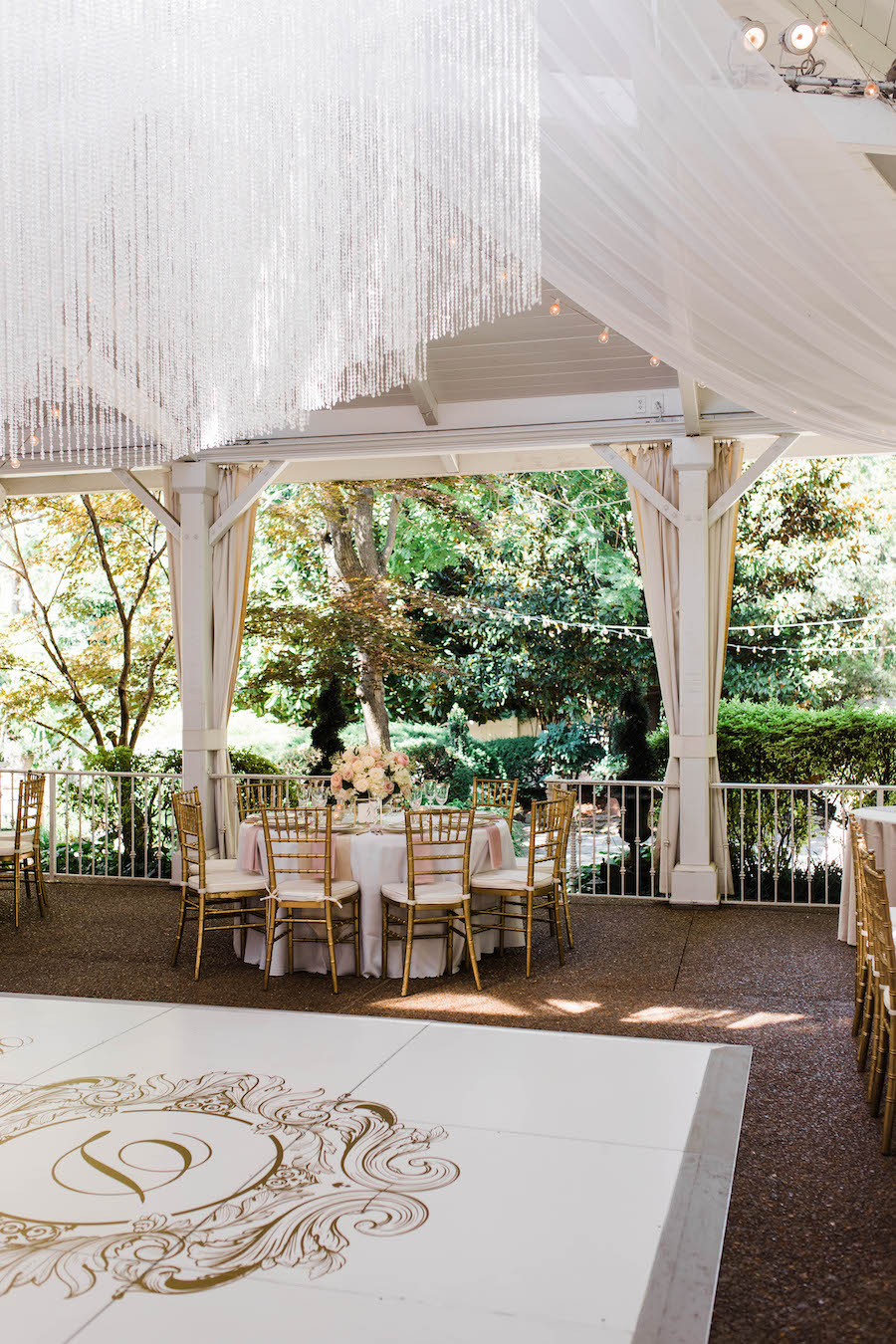 Lush Florals and Dramatic Draping create a romantic outdoor wedding reception at CJ’s Off the Square