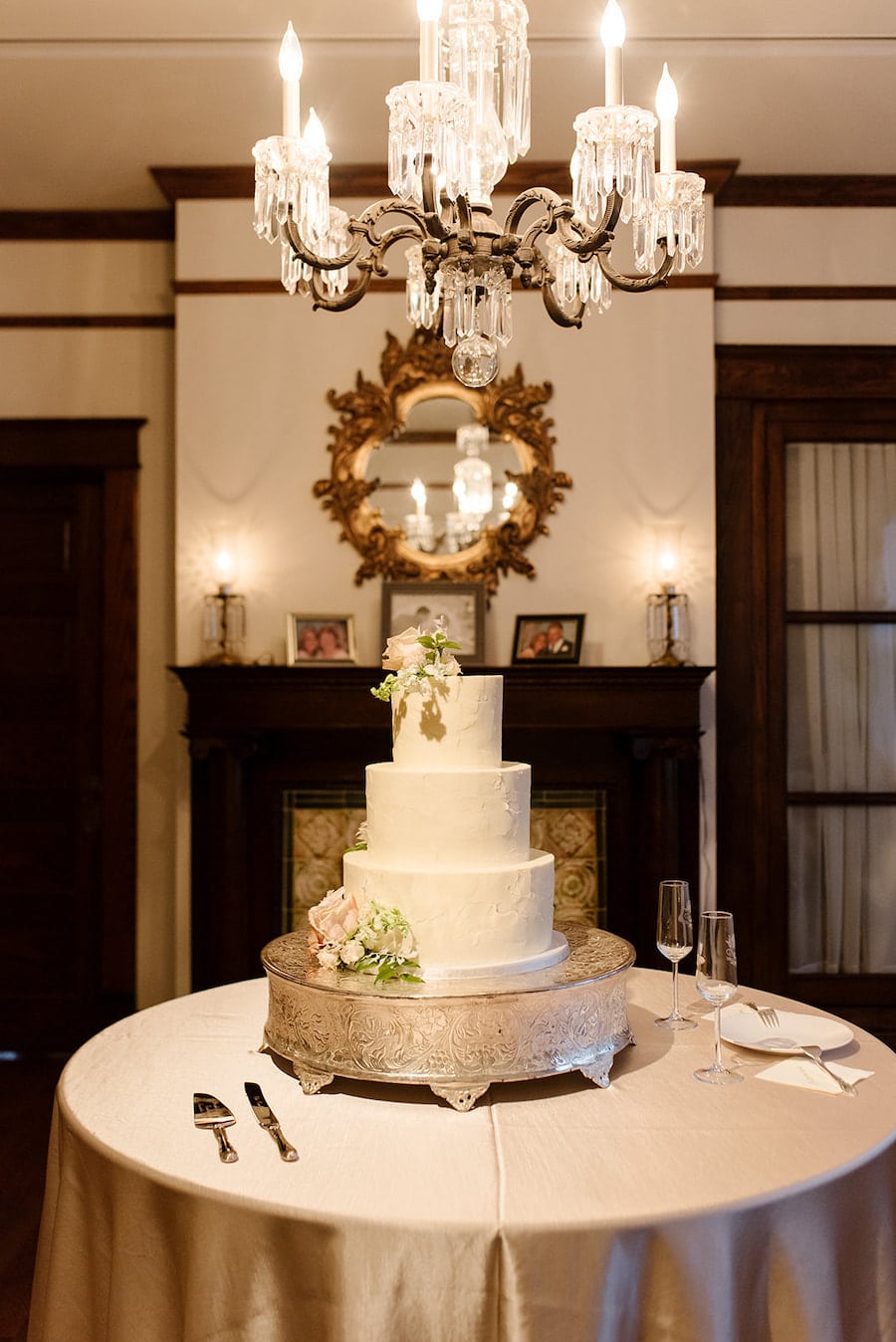 Simple but elegant wedding cake with buttercream icing and fresh flowers and greenery at garden wedding venue CJ’s Off the Square near Nashville, TN. 