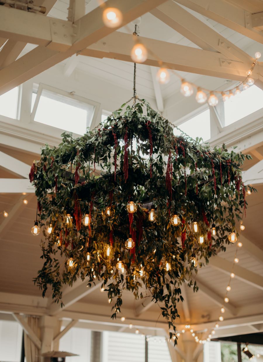 Large chandelier with greenery and hanging lights / earthy / fall / October / burgundy