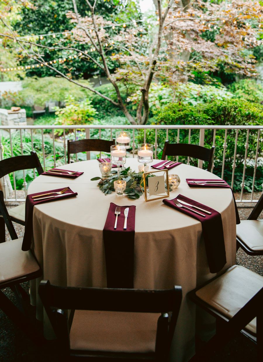 wedding reception table set up in front of gorgeous garden / earthy / fall / October / burgundy