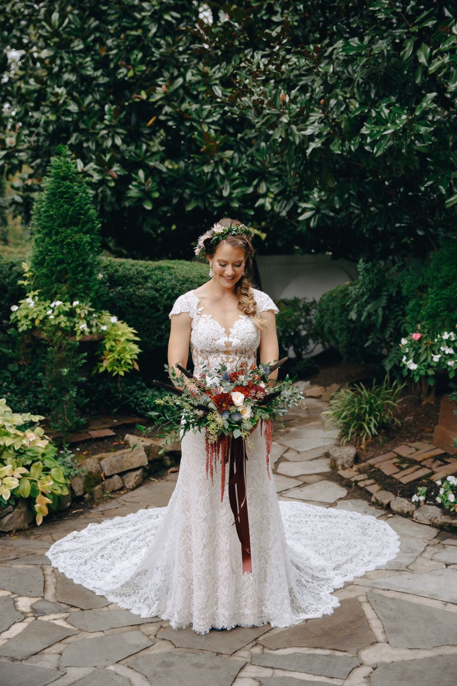 Bride in lace wedding gown holding her bouquet / earthy / fall / October / burgundy