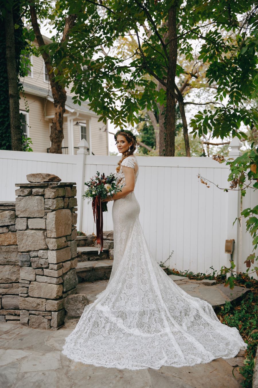 Bride posing with gorgeous long lace train / earthy / fall / October / burgundy