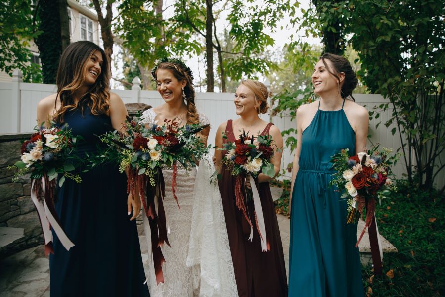 Bride and bridesmaids laughing during portraits / earthy / fall / October / burgundy