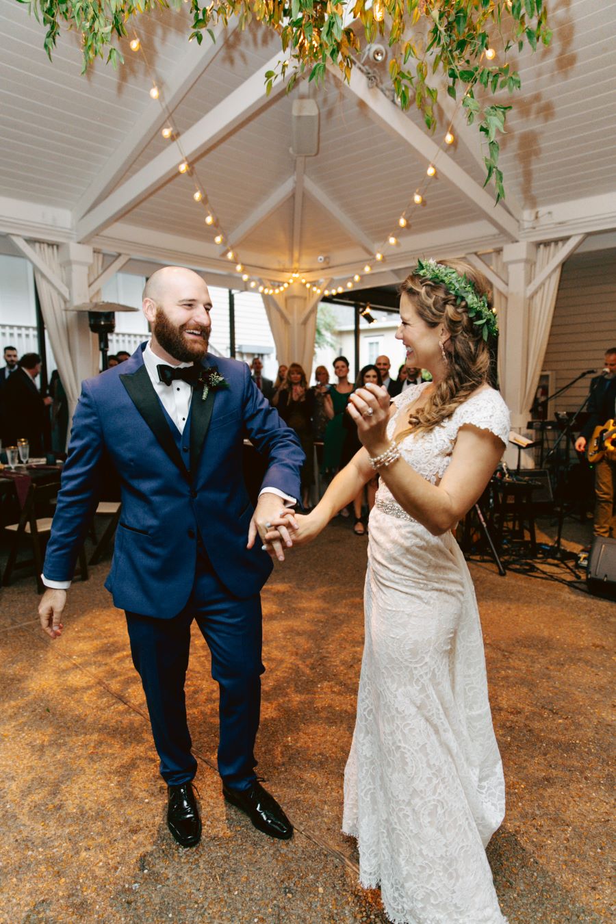 Bride and groom having first dance under leafy chandelier / earthy / fall / October / burgundy