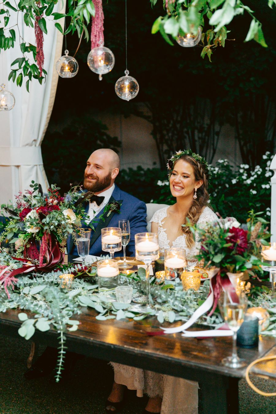 Bride and groom sitting at the head table / earthy / fall / October / burgundy