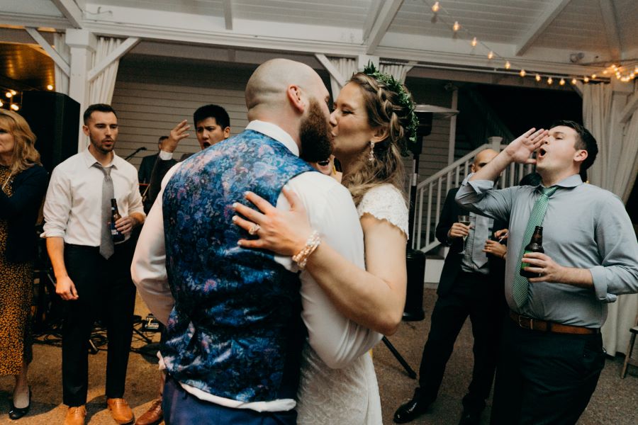 Bride and groom kissing on the dance floor during reception / earthy / fall / October / burgundy