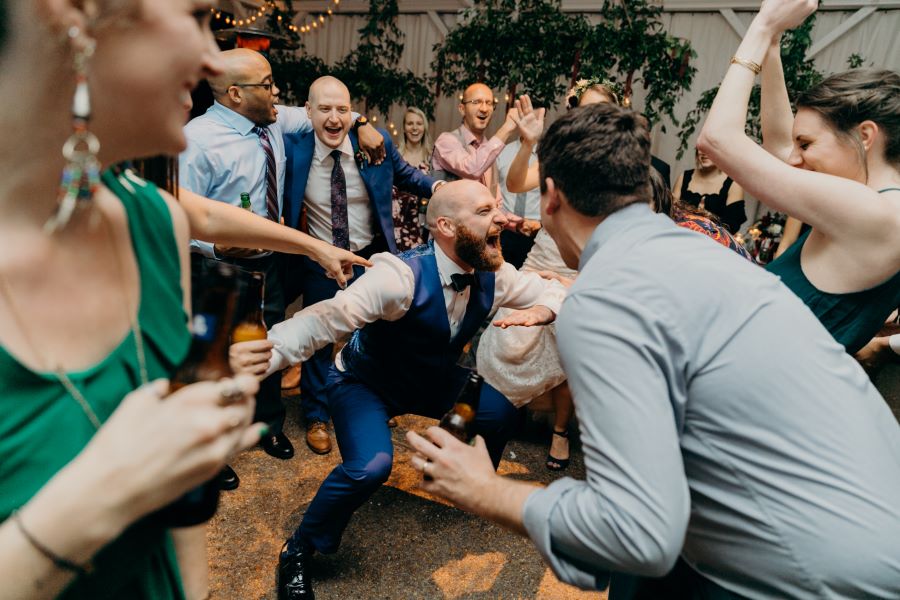 Groom getting down on the dance floor while being cheered on / earthy / fall / October / burgundy