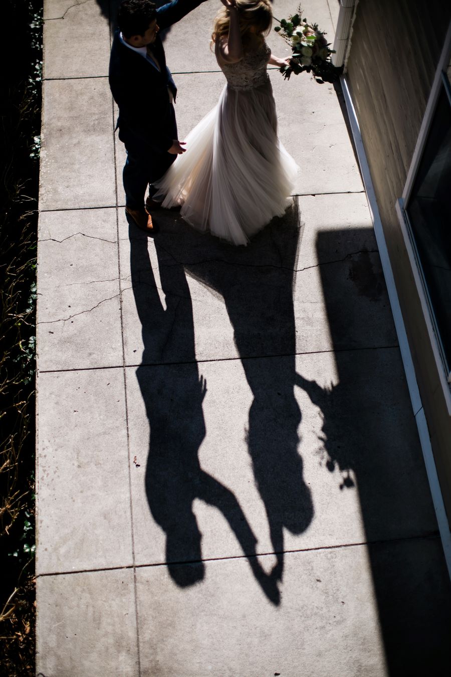 Shadow of groom twirling the bride on the sidewalk / Elopement / Spring / March / Dusty Rose