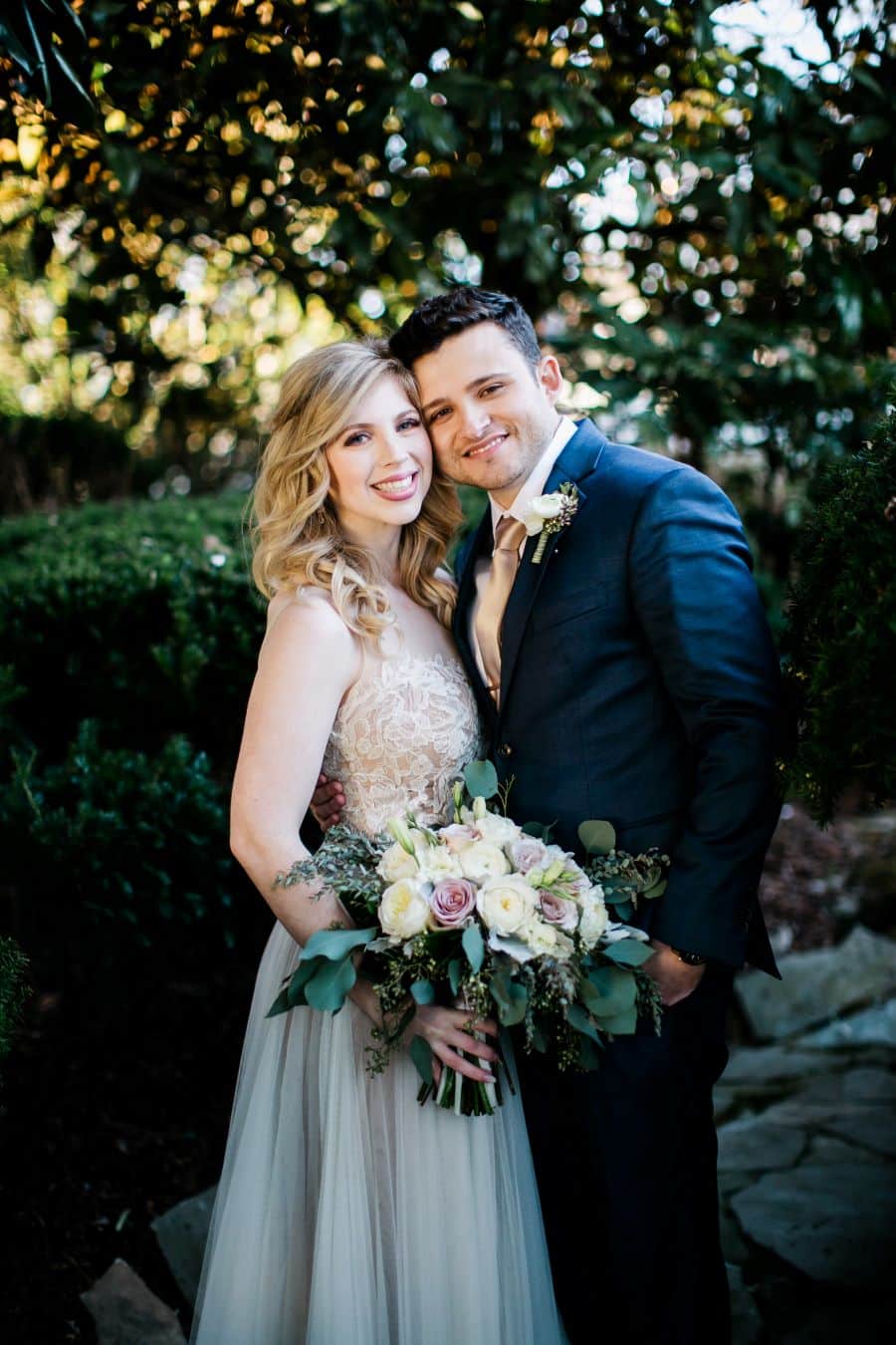 Bride and groom smiling in garden portraits / Elopement / Spring / March / Dusty Rose