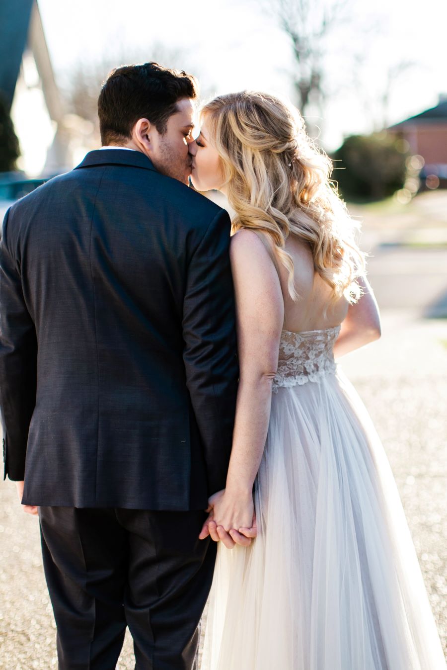 Bride and groom kissing and holding hands in the street/ Elopement / Spring / March / Dusty Rose