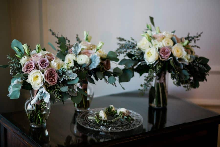 Bouquets and boutonnieres grouped together on table before wedding / Elopement / Spring / March / Dusty Rose