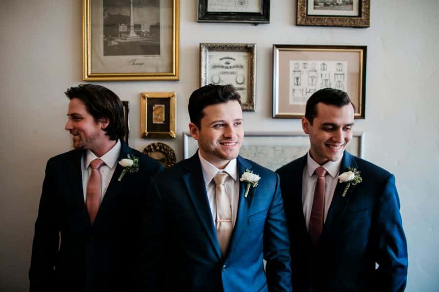 Groom and two groomsmen smiling and looking away from camera / Elopement / Spring / March / Dusty Rose