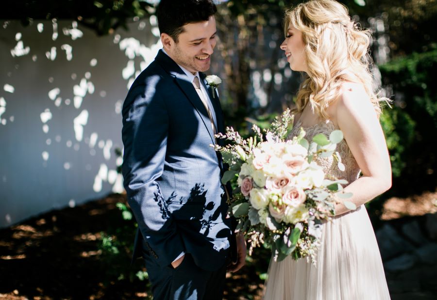 Bride and groom smiling and laughing in the garden / Elopement / Spring / March / Dusty Rose