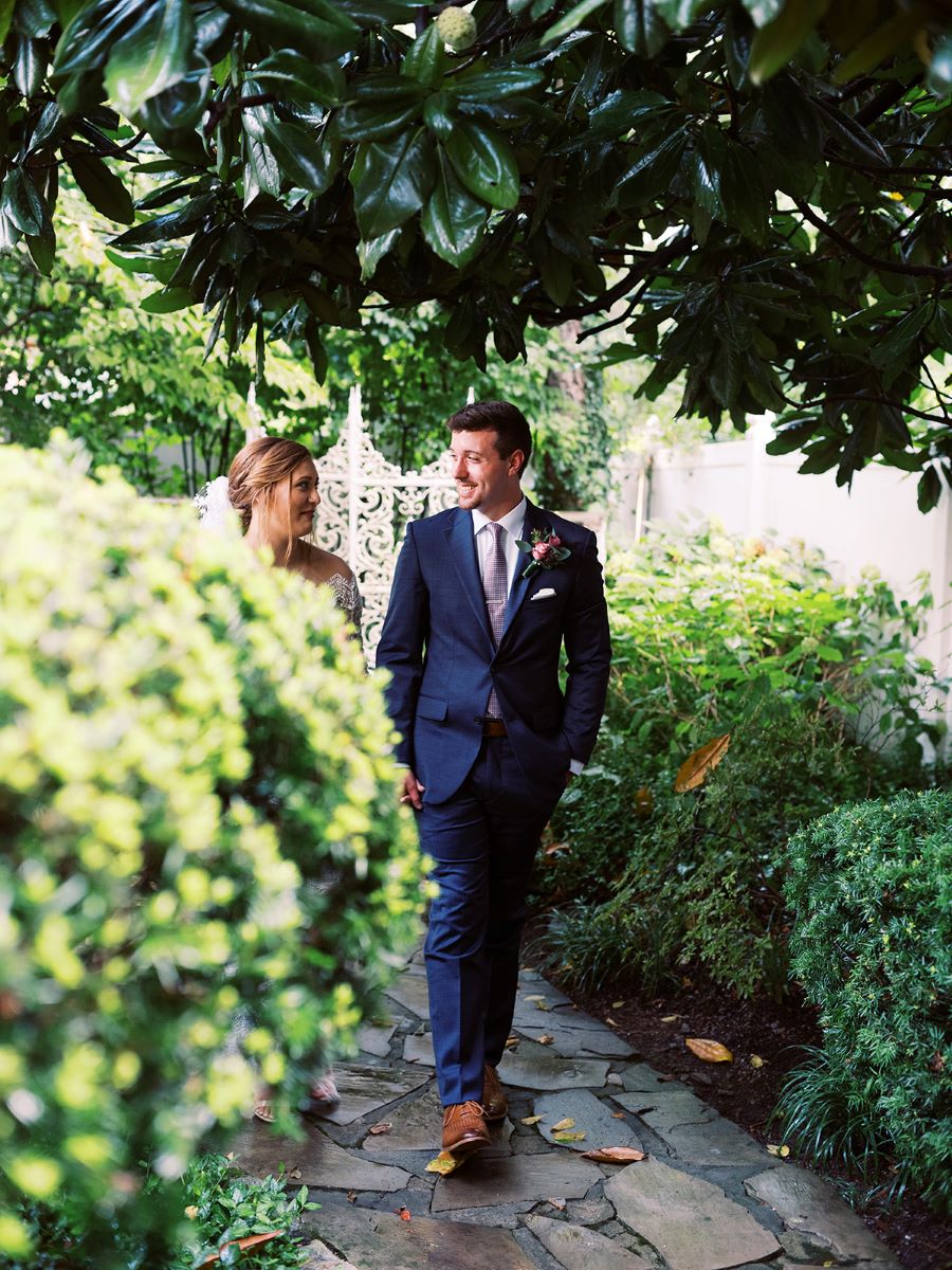 Bride and groom walking down the pathway in the garden / Elopement / Summer / August