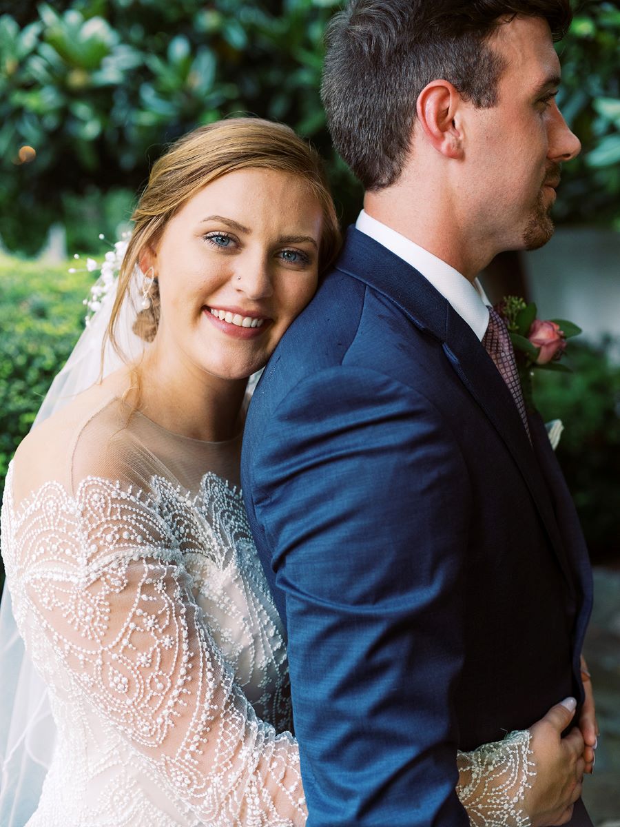 Bride smiling and hugging groom from behind / Elopement / Summer / August