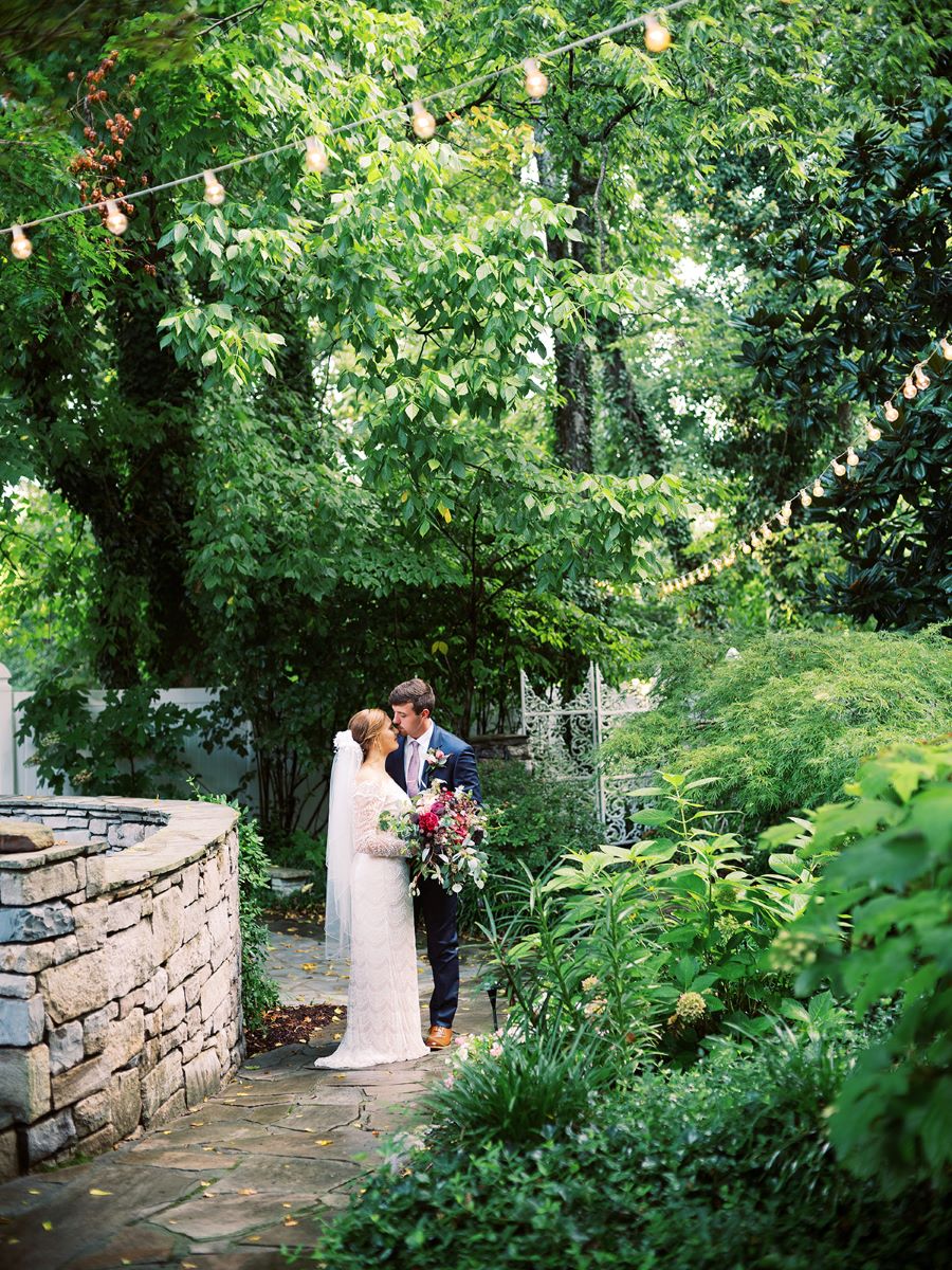 Bride and groom kissing in the garden of venue / Elopement / Summer / August