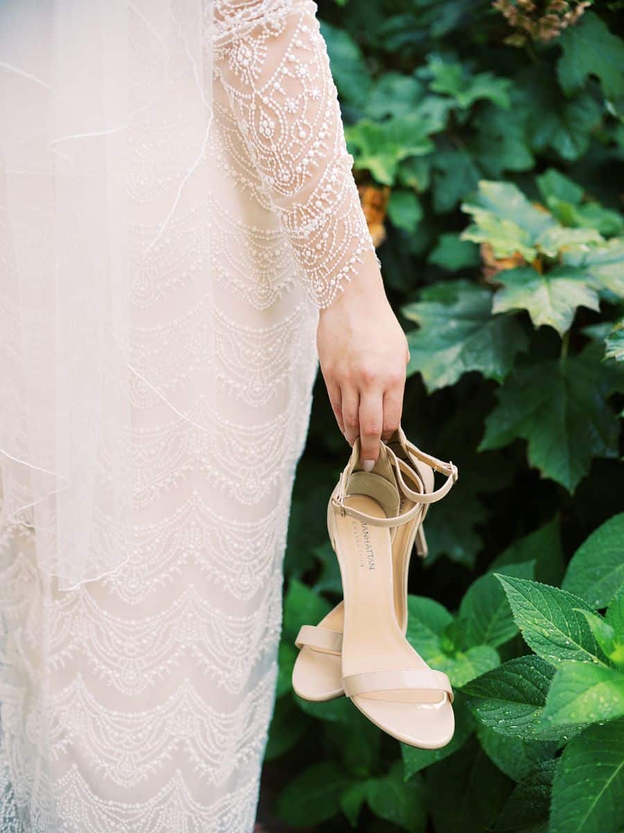 Bride holding shoes in the garden / Elopement / Summer / August