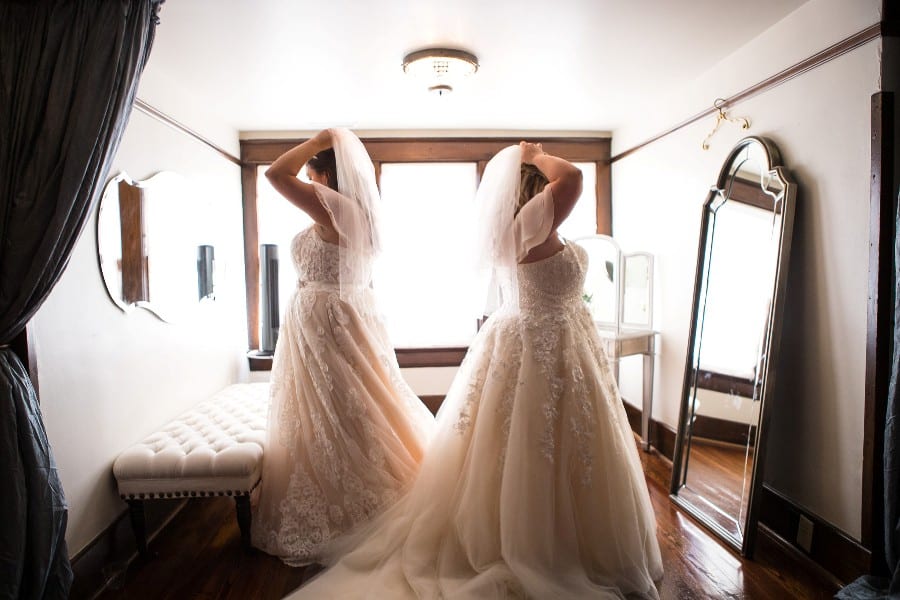 Two brides getting ready together in the dressing room