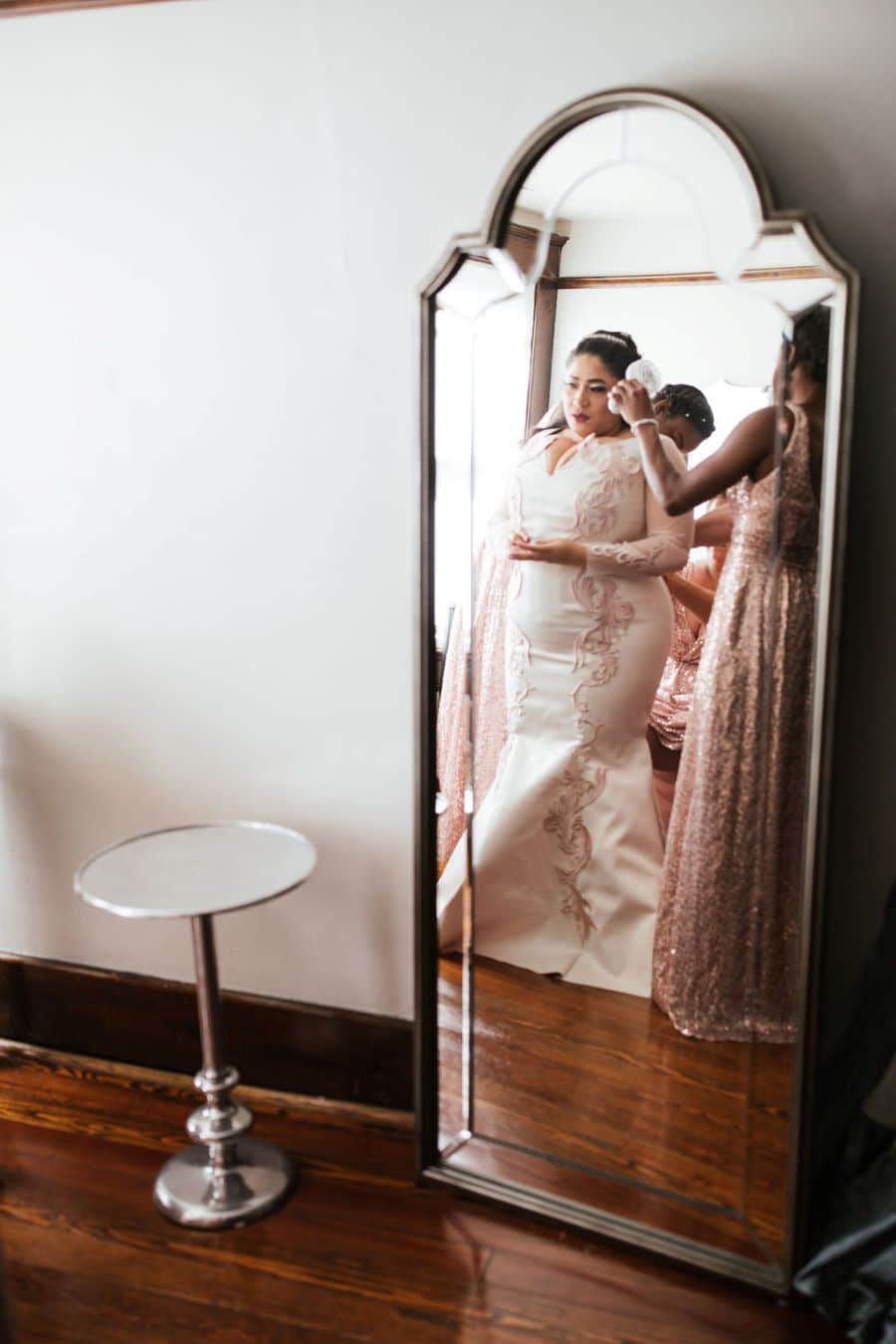 Bride getting dressed in the dressing suite of CJ's Off the Square / romantic lgbtq / fall / September / blush / burgundy