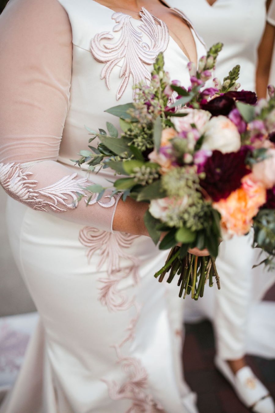 Close up of bride's long sleeve dress details and bouquet / romantic lgbtq / fall / September / blush / burgundy
