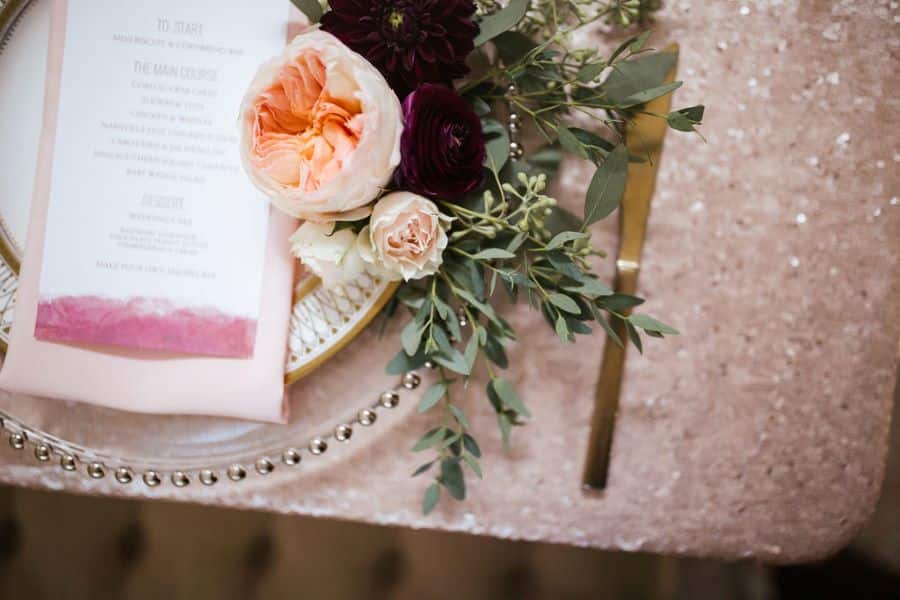Glitter tablecloths and floral accents on wedding tables / romantic lgbtq / fall / September / blush / burgundy