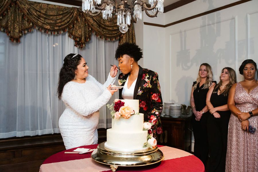 Brides feeding each other cake during wedding/ romantic / fall / september / blush / burgundy