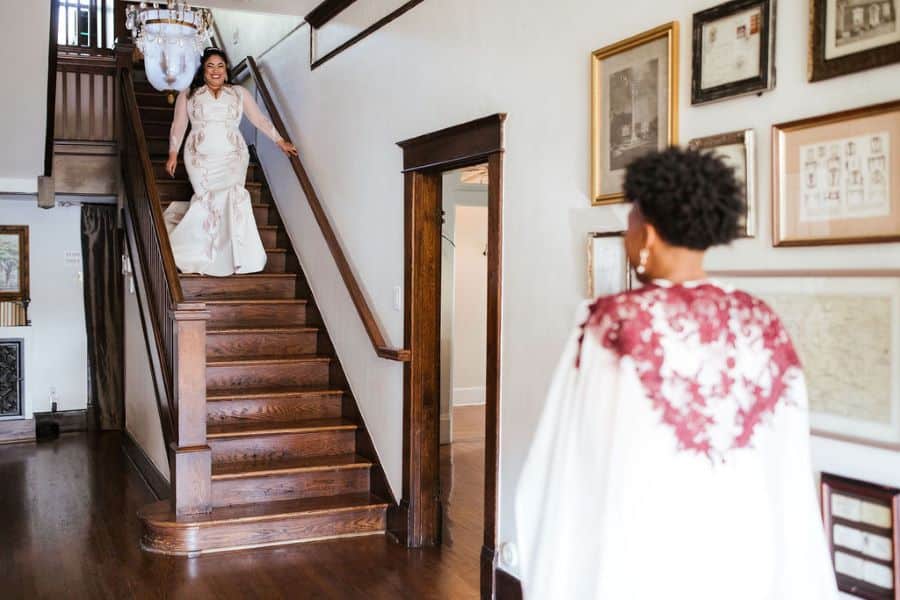 Bride walking down the stairs to greet her other bride before ceremony / two/brides/ romantic / lgbtq / fall / September / blush / burgundy
