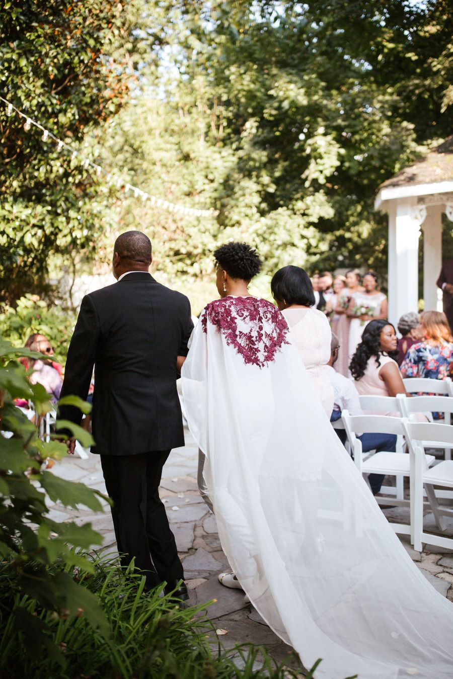 Bride's cape trailing behind her as she walks to the altar / romantic lgbtq / fall / September / blush / burgundy