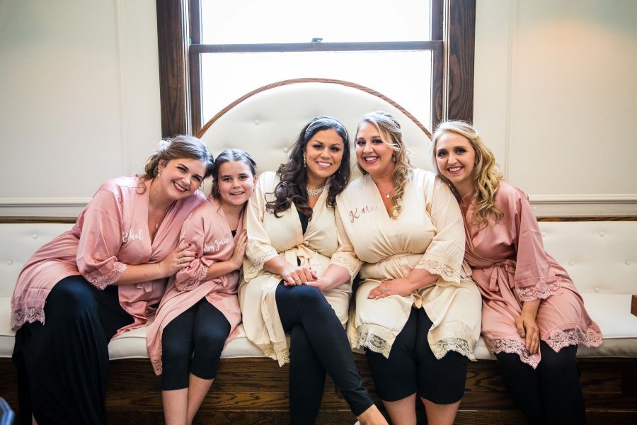 Brides sitting with bridal party before same sex garden wedding / Romantic / Summer / September / Pink / Dusty Rose / Cream