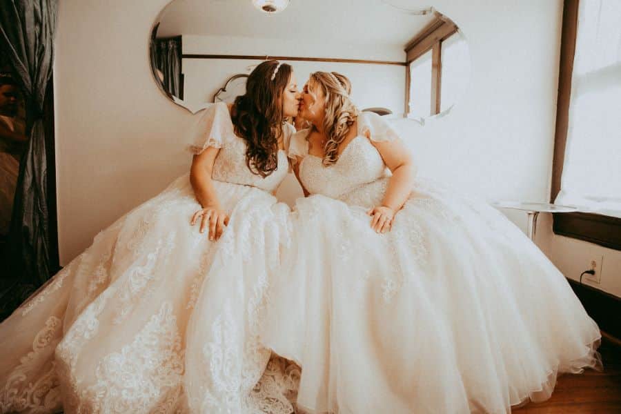Brides kissing in bridal dressing room at Nashville wedding venue / Romantic / Summer / September / Pink / Dusty Rose / Cream