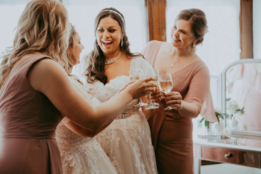 Bridal party cheers-ing in bridal dressing room of wedding venue / Romantic / Summer / September / Pink / Dusty Rose / Cream