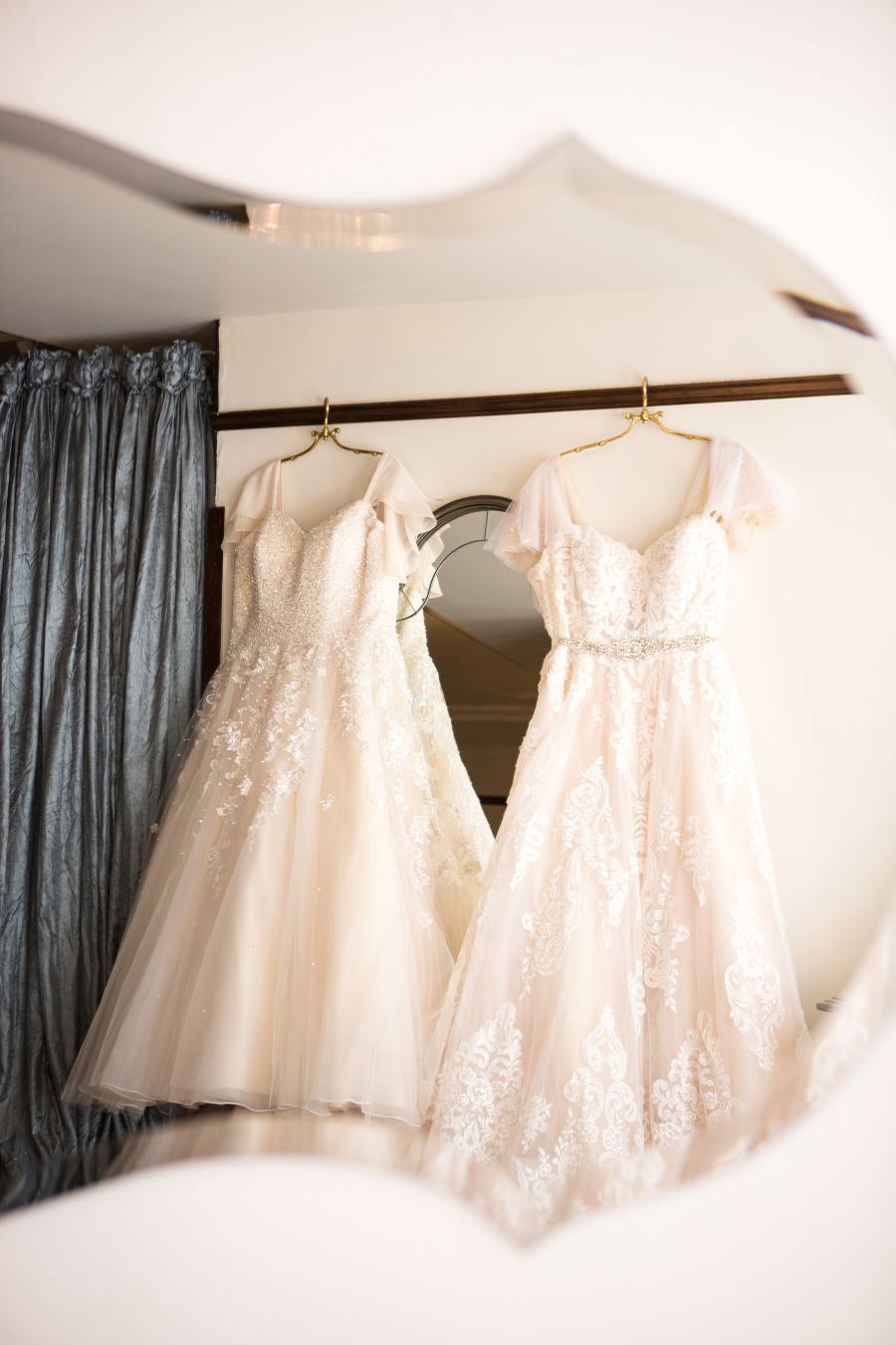 Both lace lgbt bridal gowns hanging in bridal suite of Nashville wedding venue / Romantic / Summer / September / Pink / Dusty Rose / Cream