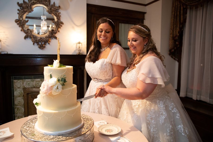 Brides cutting Love is Love wedding cake / Romantic / Summer / September / Pink / Dusty Rose / Cream