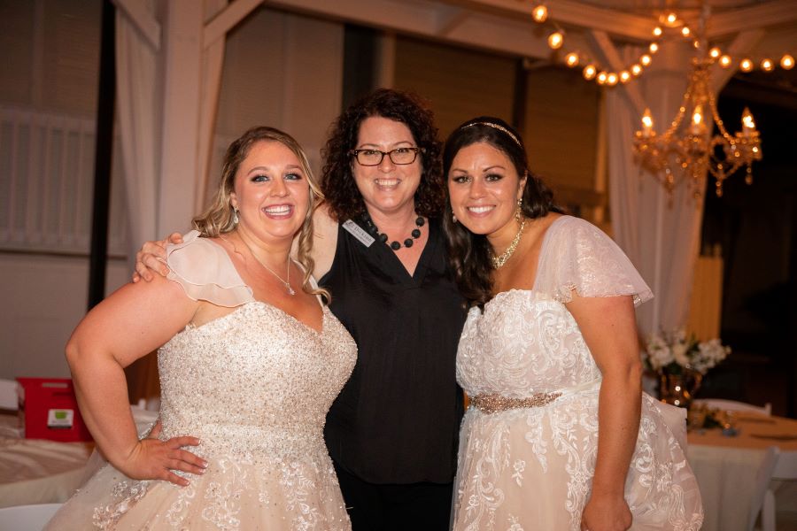 Both brides with CJ Dickson of Cj's Off the Square during their wedding / Romantic / Summer / September / Pink / Dusty Rose / Cream