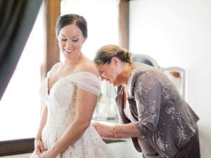 Mother of the bride buttoning the bride's gown before the ceremony / Traditional / Fall / September / Blush / Burgundy